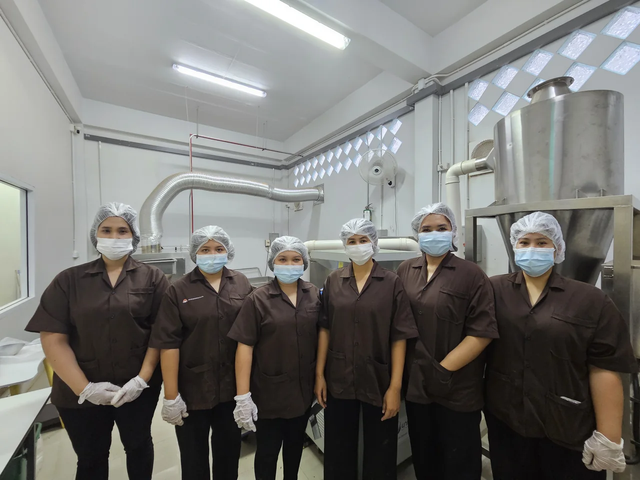 The production team wearing hair coverings and masks.